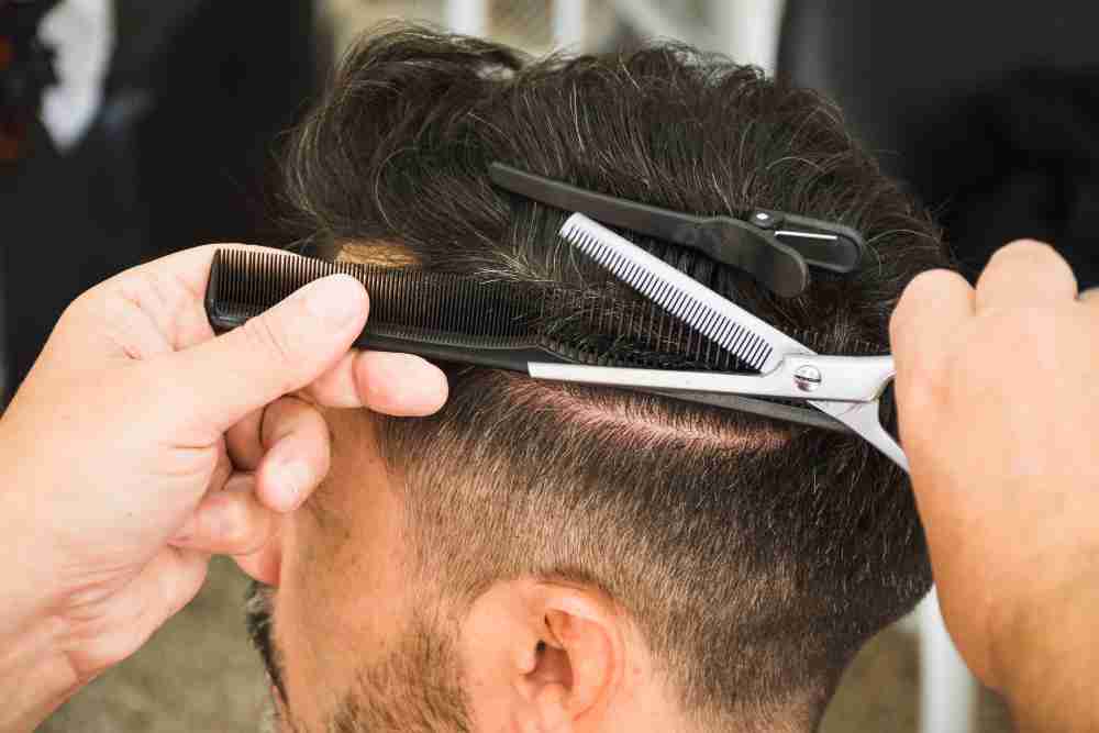 Men's Haircut barber-using-scissors Men's Haircut