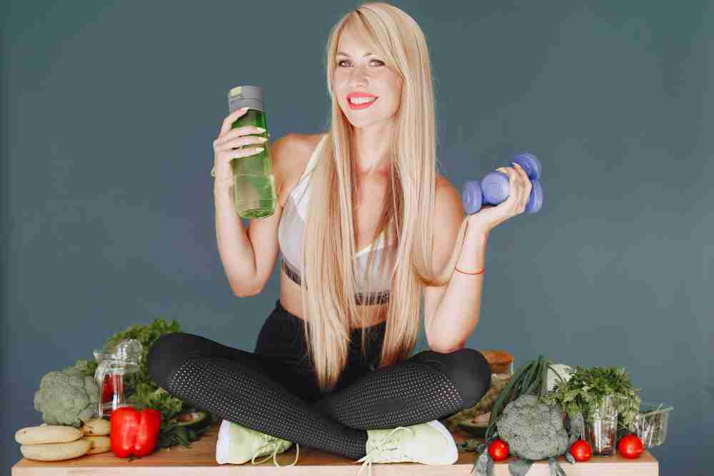Woman with great hair = healthy lifestyle Woman with great hair with weights and food